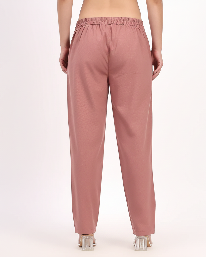 Pink pants worn by a person on a white background