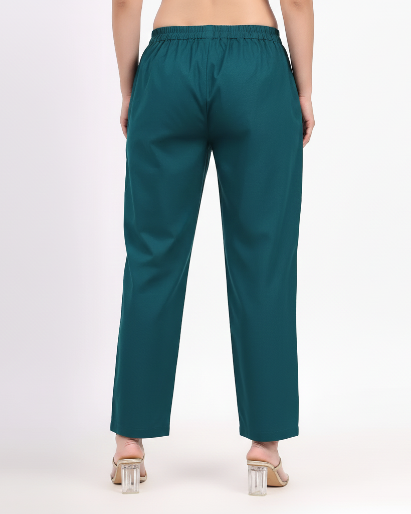 Teal pants worn by a person on a white background