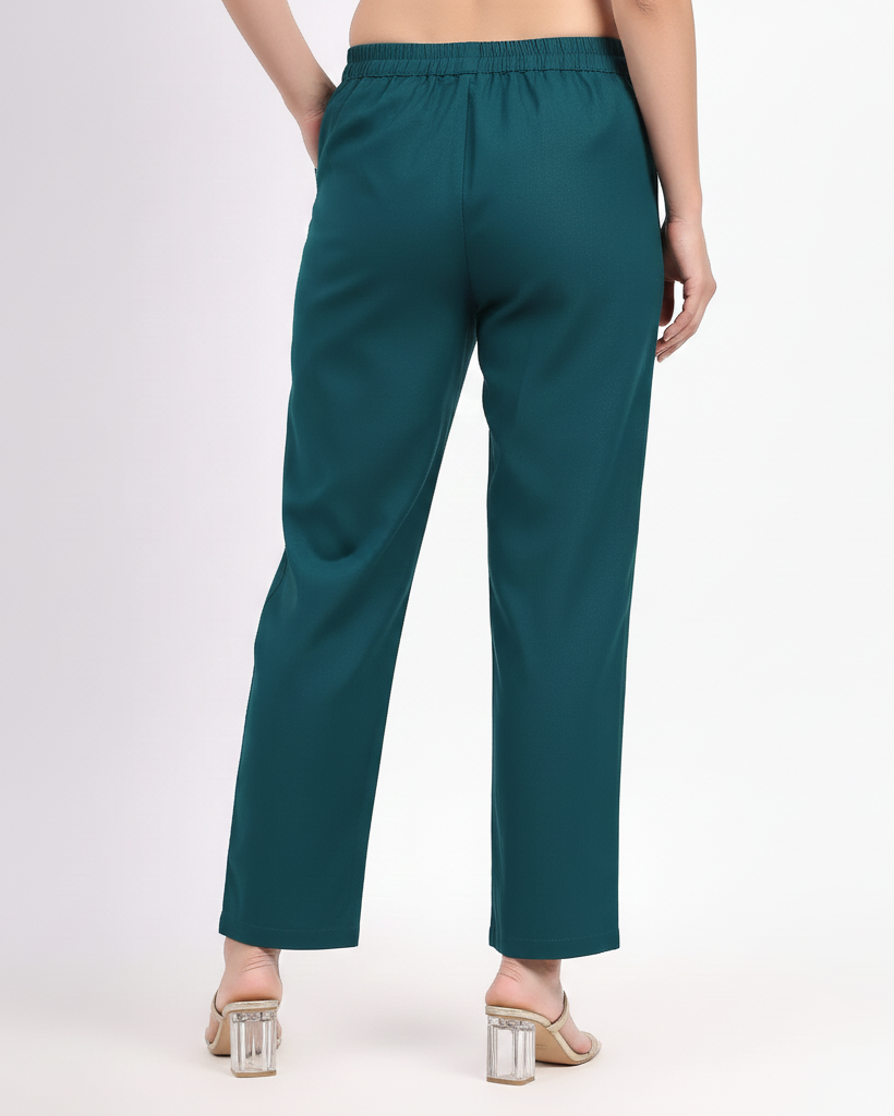 Teal pants worn by a person on a white background