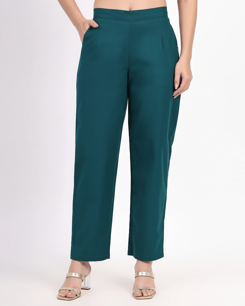 Teal pants worn by a person on a white background